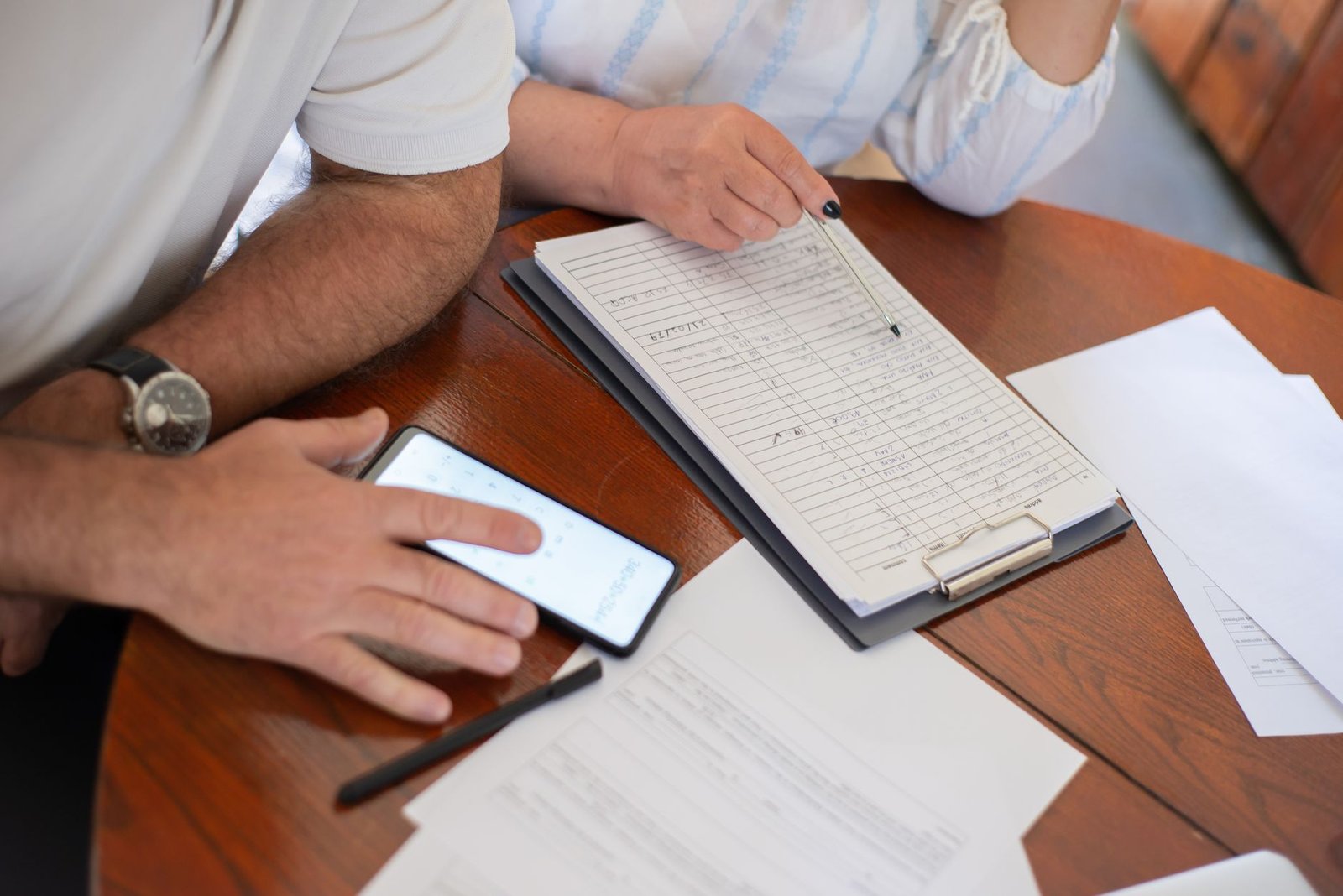 Veteran and spouse reviewing paperwork about VA benefits and Medicaid eligibility at home