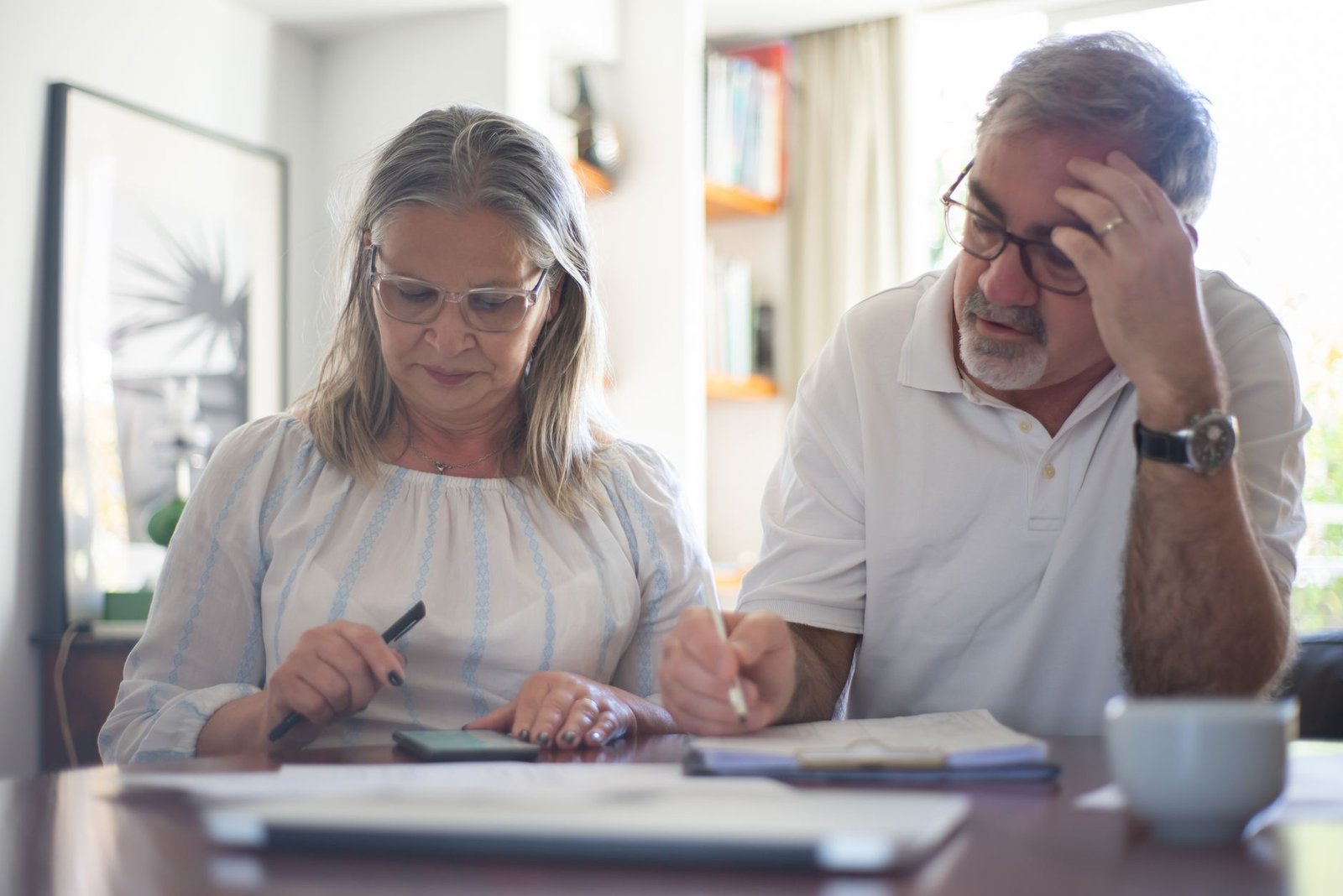 A veteran and spouse reviewing workers compensation and VA disability payment statements