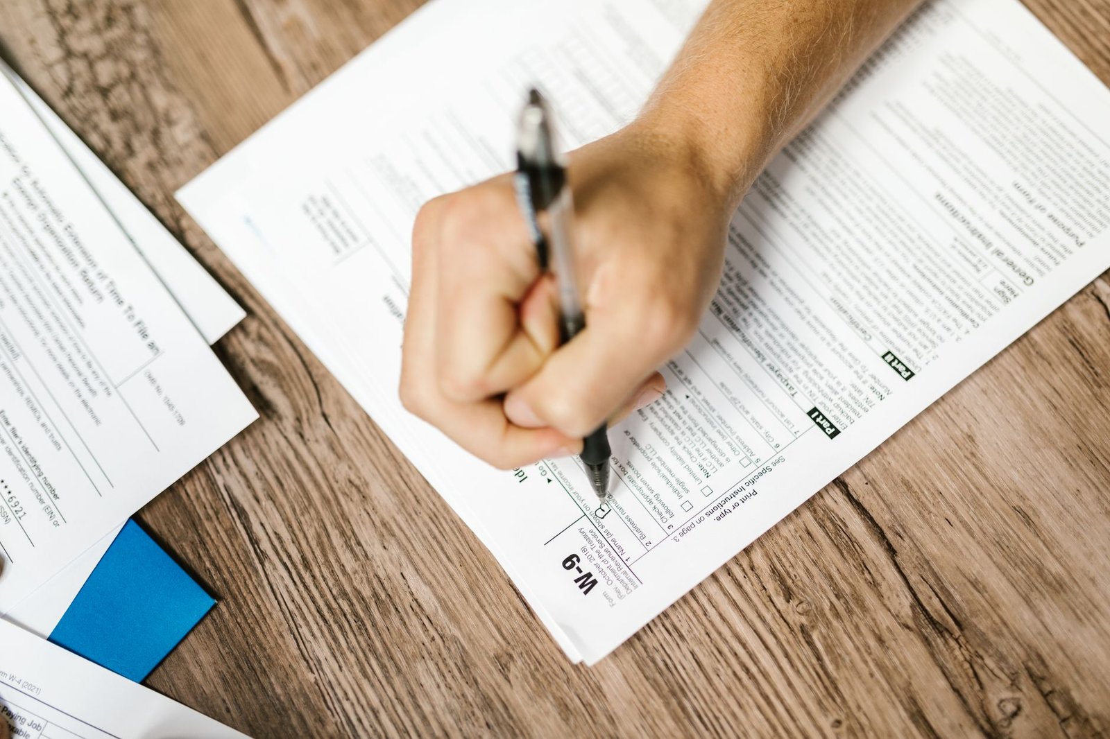 Hands completing VA accredited representative power of attorney paperwork at a desk