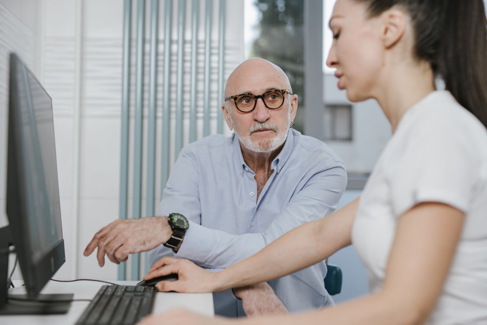 A physician meets an older veteran during an independent medical examination for VA claims