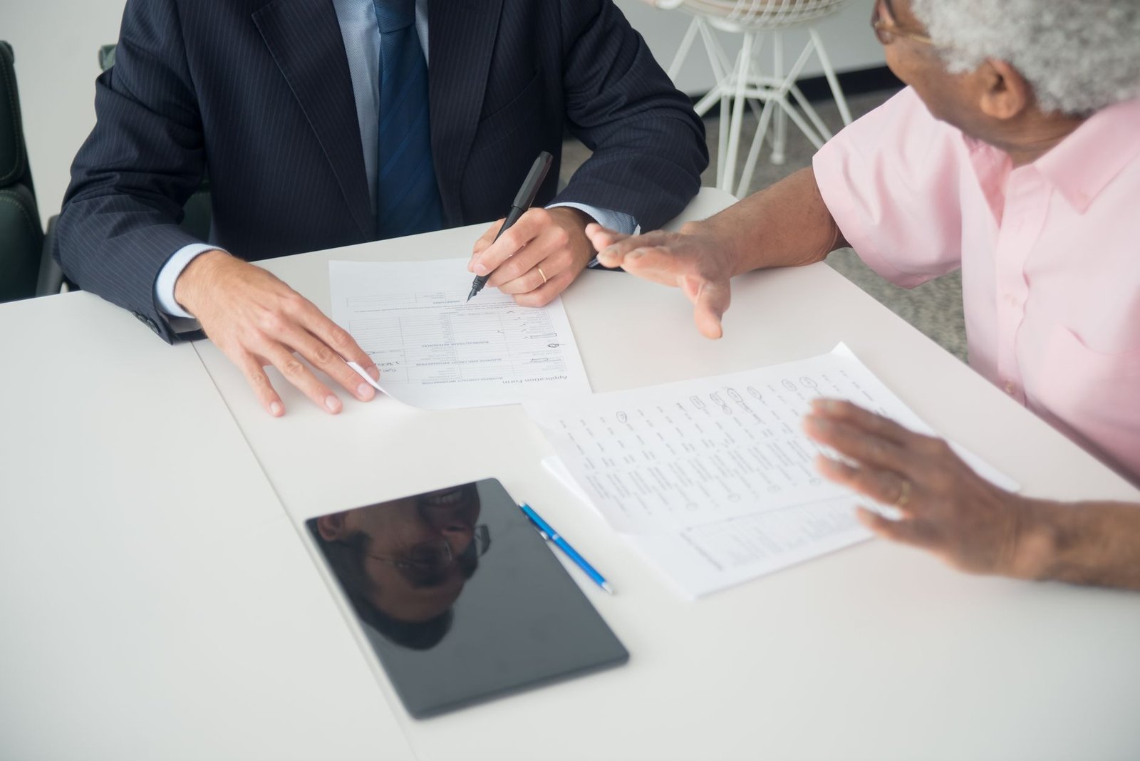 A veteran meeting an advisor at a free legal clinic for veterans to review claim paperwork