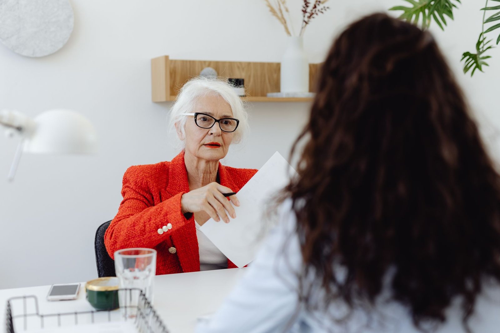 A senior veteran and an accredited advisor review paperwork about an advance on the docket for VA appeals